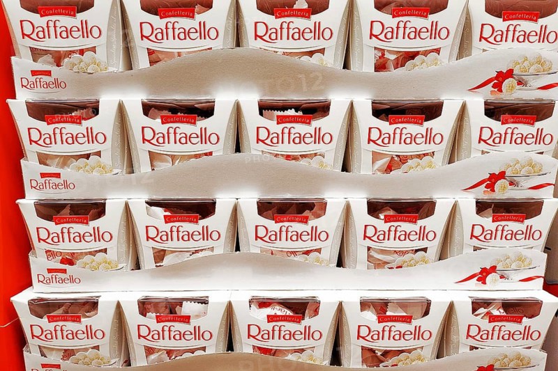 Dossneheim, Germany - April 7th 2026: Raffaello chocolate confection display in supermarket. Ferrero coconut-almond pralines arranged in retail promotional stand