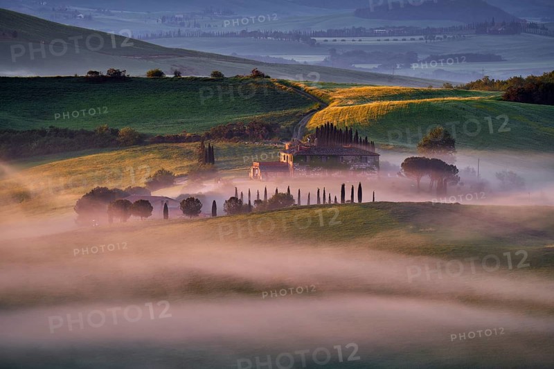 Landscape in Tuscany, near the Siana and Pienza, Sunrise morning in Italy. Idyllic view on hilly meadow in Tuscany in beautiful morning light, Italy. Foggy morning in nature