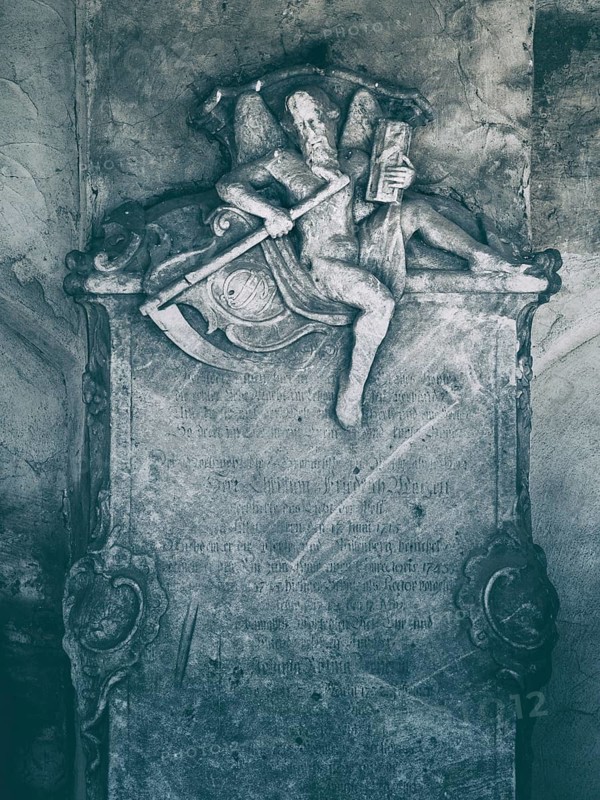 Old historic cemetery, sculpture of the Grim Reaper with scythe and hourglass as a detail of a tombstone on Camposanto, Memento Mori, Buttstädt, Thuringia, Germany