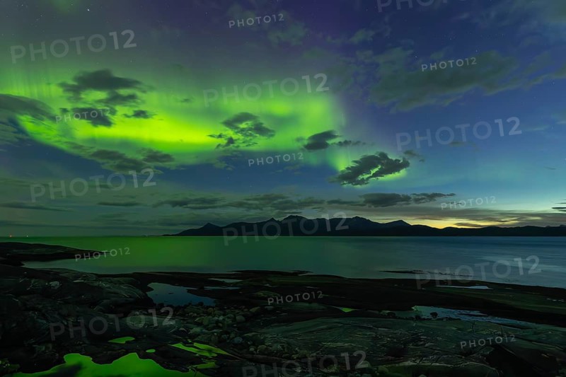 Northern lights at dawn over Sørfolda Fjord near Kjerringøy between Bodø and Sørfold in Norway