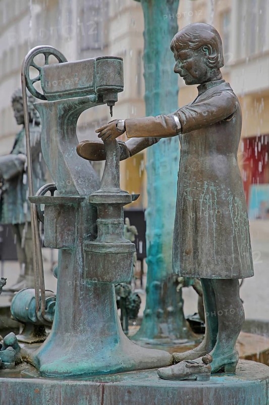 Town fountain by Bonifatius Stirnberg 2000, bronze sculptures on the historical town history with symbols for shoemaking tradition, craft, industry, quilting machine, machine, shoes, manufacture, economy, production, Weißenfels, Saxony-Anhalt, Germany