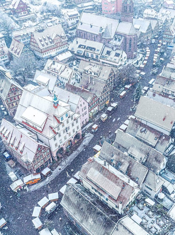 Aerial view of a snow-covered town with red roofs, Black Forest, Calw, Germany