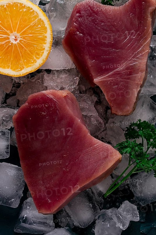 Fresh, raw steak, tuna fish, on ice, top view, close-up