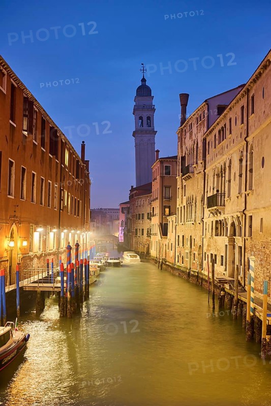 View from the bridge 'Riva degli schiavoni' over to the church 'Chiesa di San Giorgio dei Greci' at the blue hour in the evening in Venice in winter, Italy