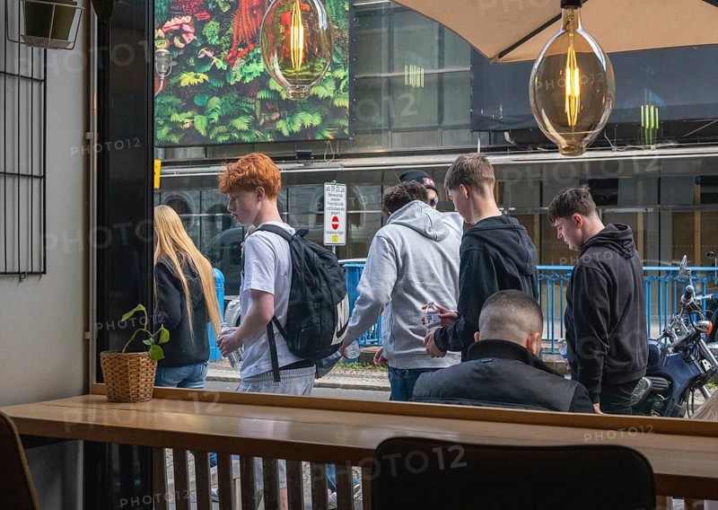 View through the window of a café of passers-by on Friedrichstraße in Mitte, Berlin, Germany