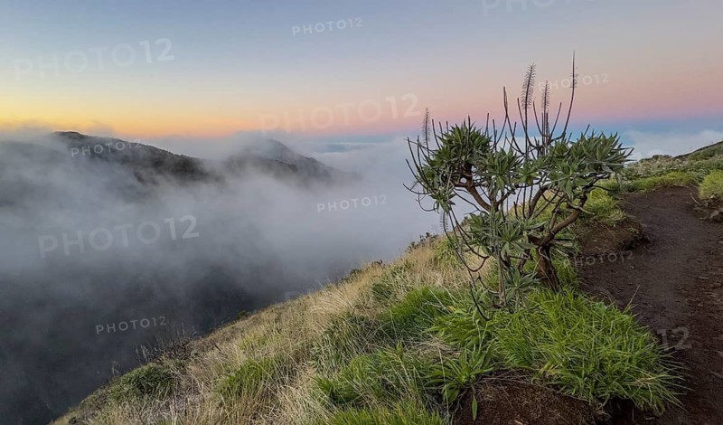 Sunrise at Pico do Arieiro, clouds of fog sweep over mountain peaks, sea of fog, hiking trail PR1, Madeira, Portugal