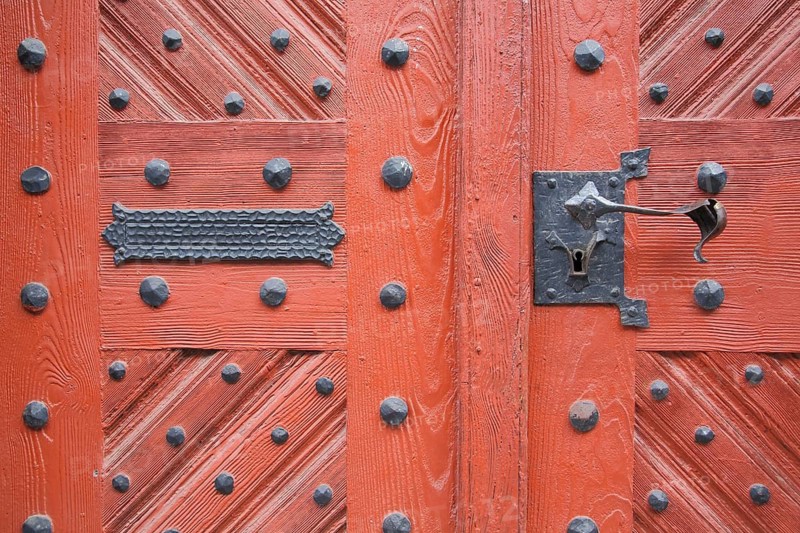 Metal fittings on red front door from town hall, rivets, mailbox slot, door handle, detail, Schotten, Hesse, Germany