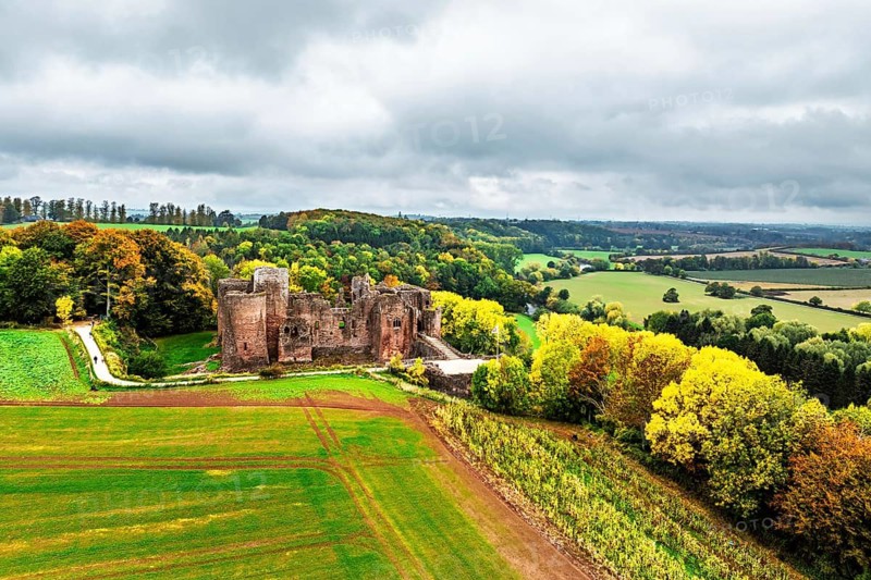 Autumn Colours over ruins of Goodrich Castle and River Wye from a drone, Goodrich, Herefordshire, England, United Kingdom