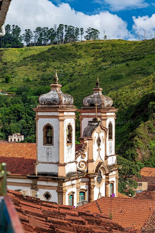 Historic Baroque church tower rising from the rooftops of the city of Ouro Preto, Ouro Preto, Minas Gerais, Brazil