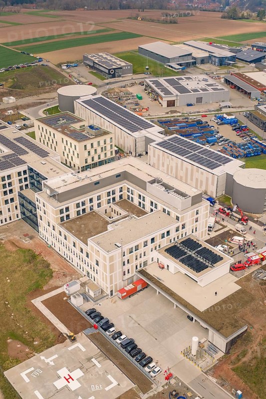 Aerial view of a modern industrial park with solar panels on building roofs, opening hospital, Calw, Germany