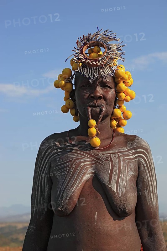 South Ethiopia, in the Maco National Park, woman from the Mursi tribe, Mursi woman with naked upper body and painted skin, Ethiopia