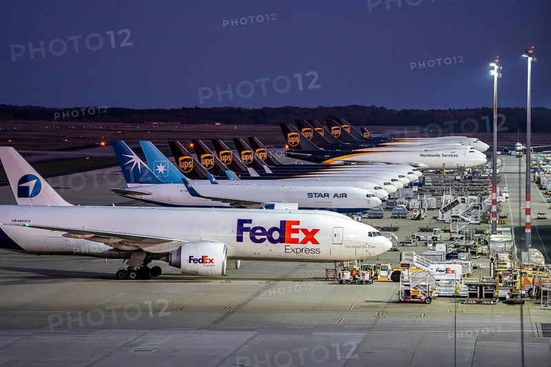Cologne-Bonn airport, CGN, air freight center, UPS Logisic Hub, UPS cargo aircraft on the apron, FedEx and Star Air Cargo aircraft, Maersk, at the logistics center, in the evening