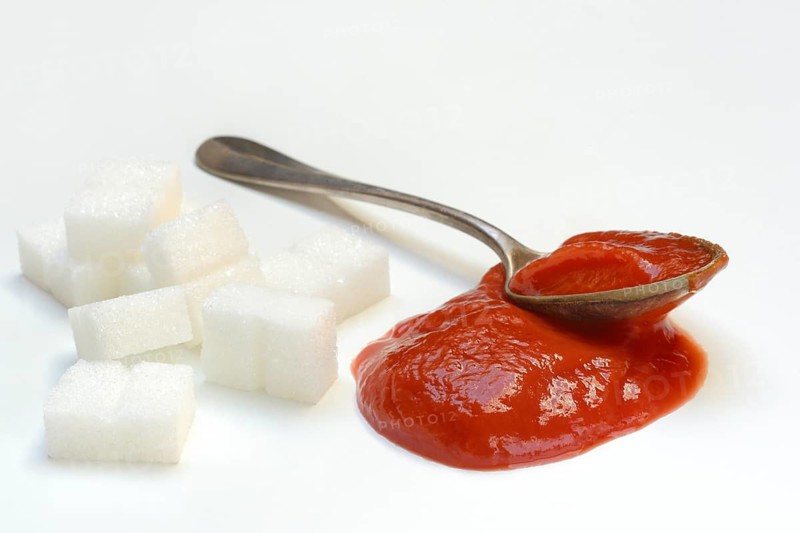 Ketchup in spoons and sugar cubes, sugar consumption