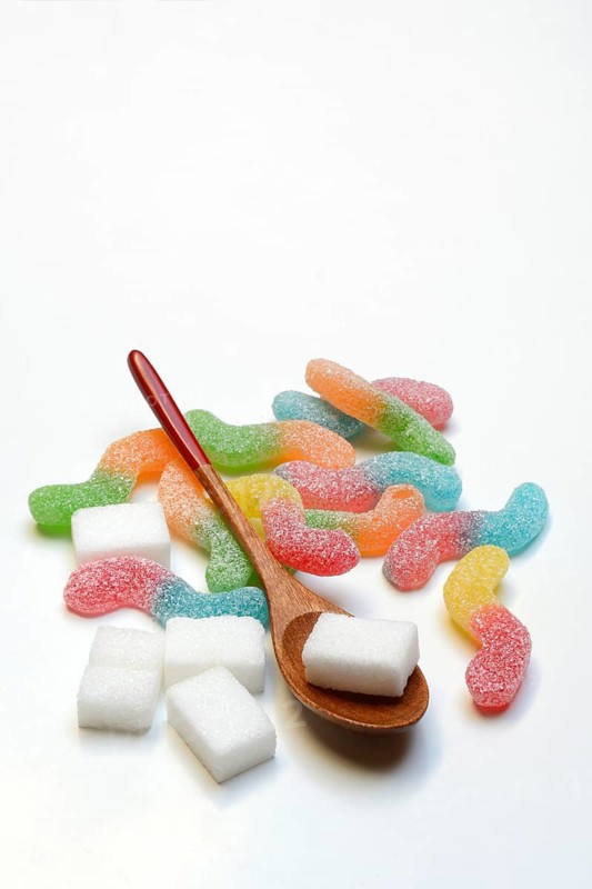 Lots of colorful jelly candies and sugar cubes, sugar consumption