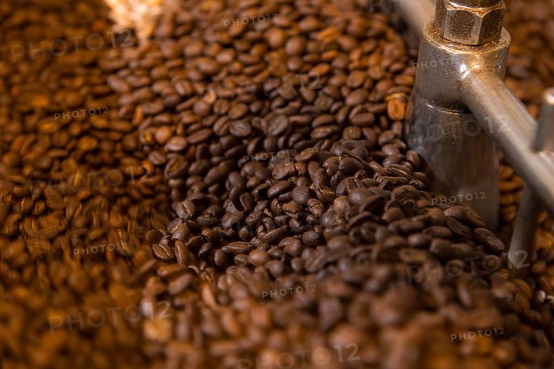Coffee is roasted by hand in a small drum roaster with lots of experience, where the hot freshly roasted coffee beans cool down using air in a sieve, Kaffeerösterei Müller, Wildenhain, Großenhain, Saxony, Germany