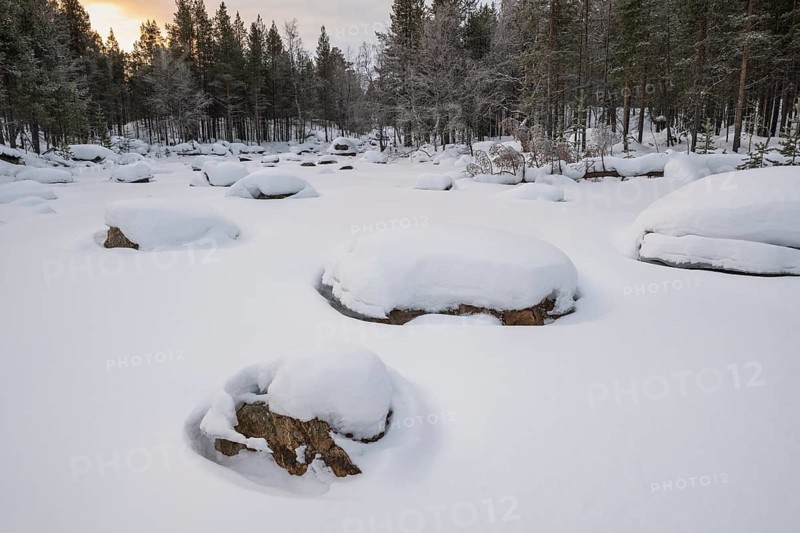 Frozen and snowy stream, Lapland, Finland, January 2025