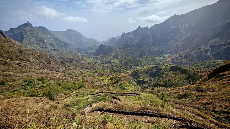Panoramic, spectacular view over a valley with a winding path, hiking trail and mountains in the background, hiking from Cova Crater through Paul Valley, Ribeira do Paul to Vila das Pombas, Santo Antao, Cabo Verde, Cape Verde, Cape Verde