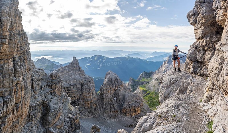 Climbers on a rock band, Bocchette Centrale band trail, via ferrata in the Brenta Mountains, Brenta-Adamello Natural Park, Trentino, Italy