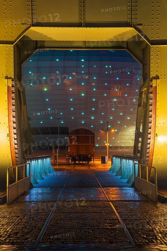 View of the Klimahaus in Bremerhaven at night through a historic bascule bridge, Bremerhaven, Bremen, Germany