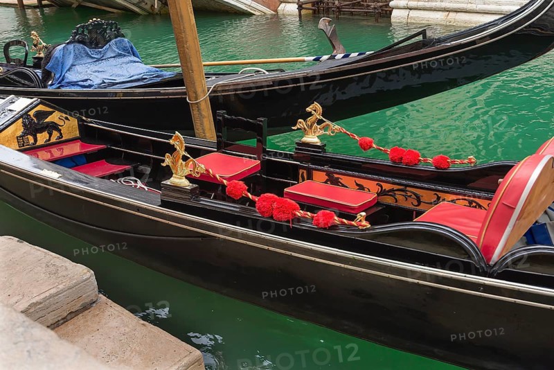 Decoratively furnished gondola with red seats, Venice, Veneto, Italy