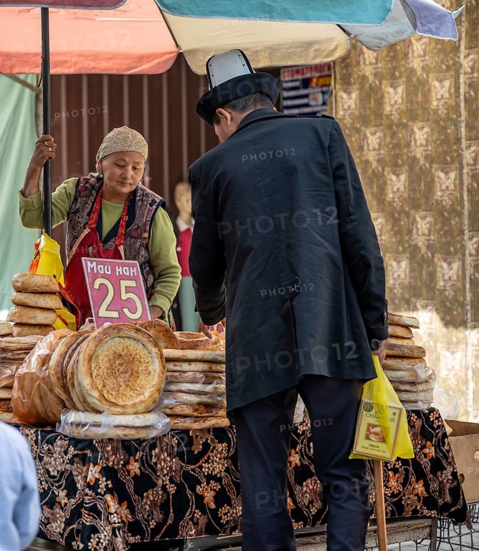 Woman selling bread at the Osh Bazaar, Bishkek, Kyrgyzstan
