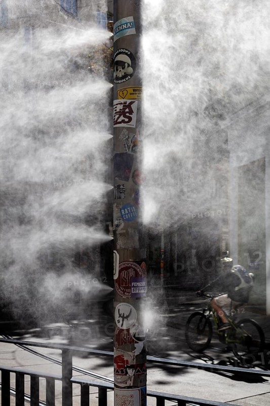 Cyclist through dense fog on an urban street, Vienna