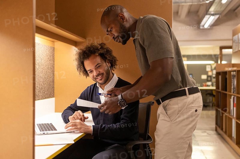 Professionals collaborating in a cozy coworking space in Barcelona, highlighting teamwork, creativity, and a productive atmosphere in a stylish office environment with modern amenities