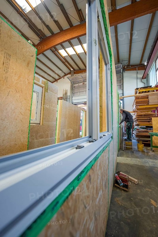 Installation of windows in a wooden structure within a workshop, façade construction in carpentry, climate-friendly construction, Nagold, Germany