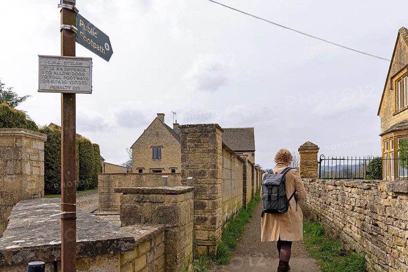 Signpost, footpath to Batsford Arboretum, woman, pedestrian, Moreton-in-Marsh, Cotswolds, England, Great Britain