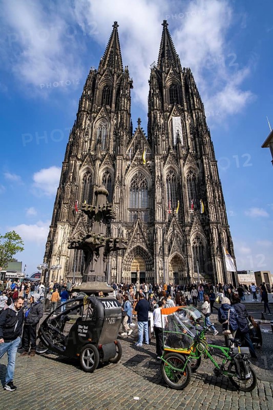 Cologne Cathedral, view of the west facade, on the north tower one of the rare occasions almost without scaffolding on the towers, bicycle taxi, Cologne, Germany