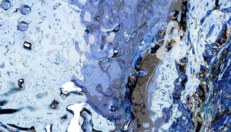 Abstract image showcasing blue and white fluid textures resembling flowing water. Features intricate patterns and reflections, evoking motion and tranquility