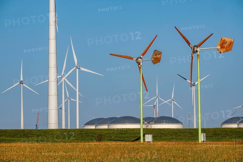 Mini wind turbines, from the Dutch company Ecoways EAZ wind turbine, produces up to 15 kW of power and up to 45, 000 kW of electricity per year, for self-consumption, intended primarily for farms, rotors made of wood, from forests in the Netherlands, easy to recycle, quick simple set-up, for cheap power supply in the countryside, behind large wind turbines of a wind farm near Eemshaven, Vopak Tanklanger, the Netherlands