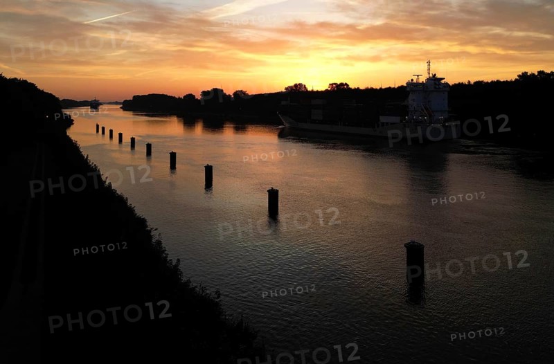 Drone shot, container ship at sunrise in the Kiel Canal, NOK, Kiel Canal, Kiel Canal, Schleswig-Holstein, Germany