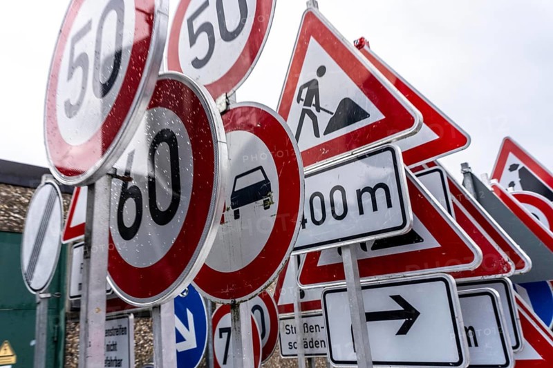 Storage for traffic signs in the yard of a road maintenance department, various signs with commandments and prohibitions, information about dangers, road traffic