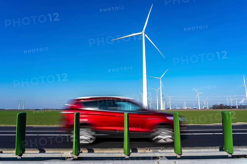 Wind farm in the north of the Netherlands, near Eemshaven, energy center, in addition to wind energy, there are coal and gas power plants and various energy infrastructure facilities, country road, Netherlands