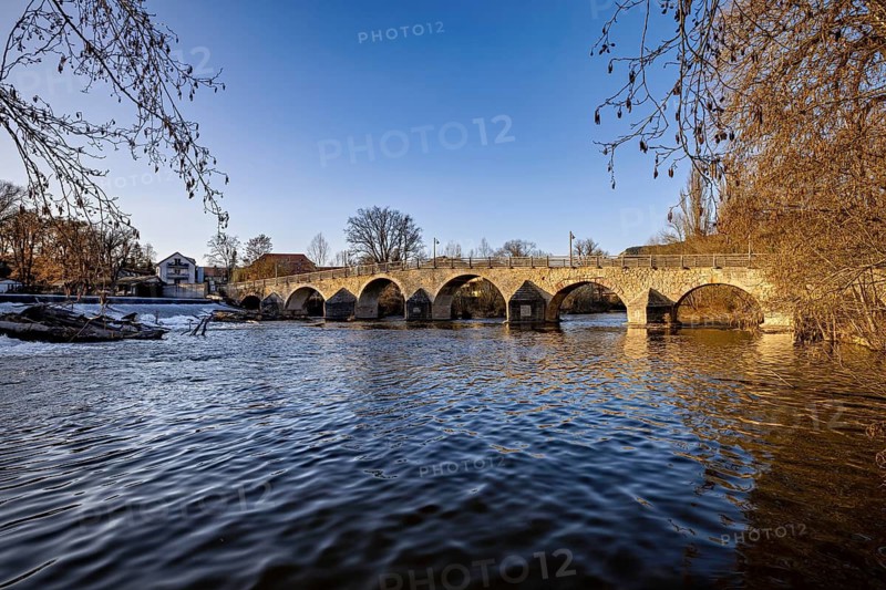 Day overview of the river and a rustic stone bridge under a clear blue sky, The Burgau Bridge in the Saale Valley near Jena in Thuringia