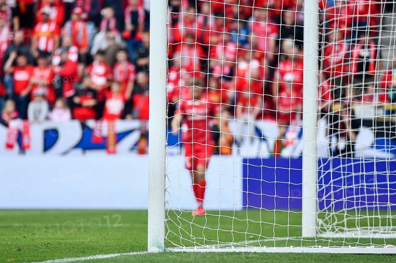Soccer goal post and soccer match in the background in Lodz, Poland