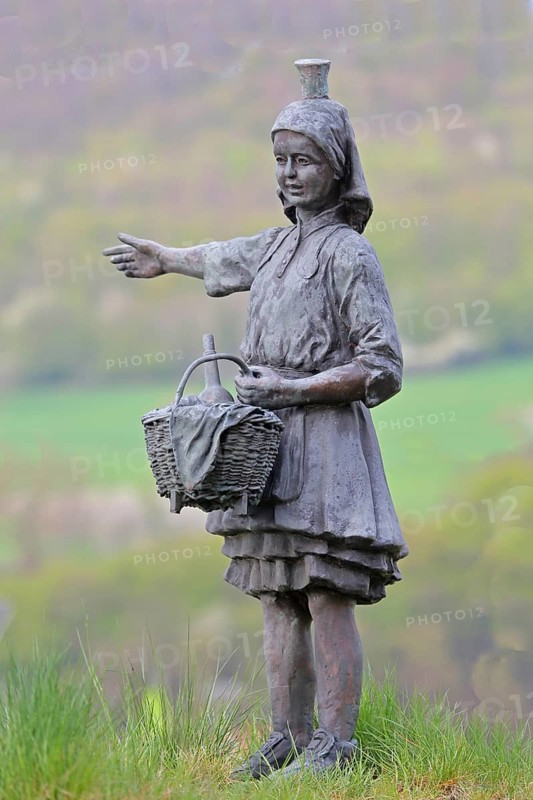 Little Red Riding Hood sculpture by Ewald Rumpf 2010, modern art, bronze sculpture, girl with wicker basket and traditional costume, fairy tale figure, gesture, arm stretching, Deutsche Märchenstraße, Remsfeld, Knüllwald, Knüllgebirge, Hesse, Germany