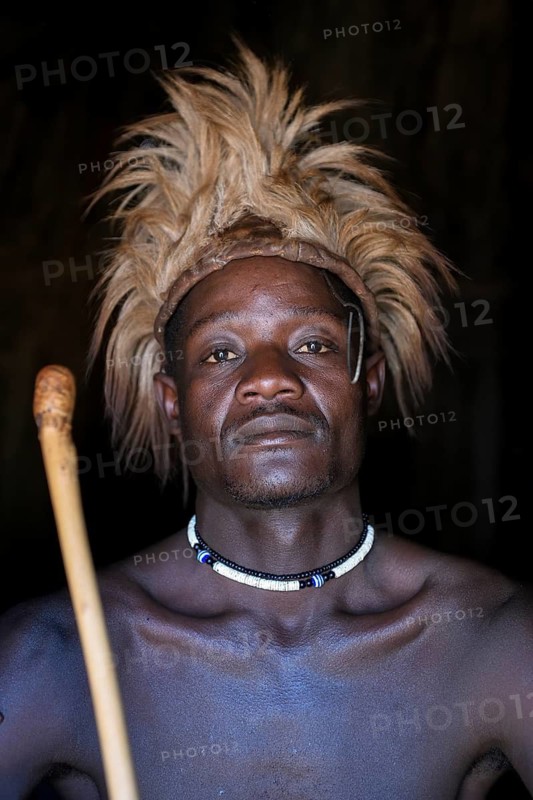 Young Himba man in his hut, Ohandungu, Kunene region, Kaokoveld, Namibia