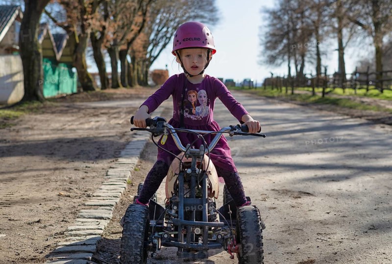 Girl, 4 years, blonde, crash helmet, riding quad, children's quad bike, Sonnenhof, Erlebnisbauernhof, Stuttgart, Baden-Württemberg, Germany