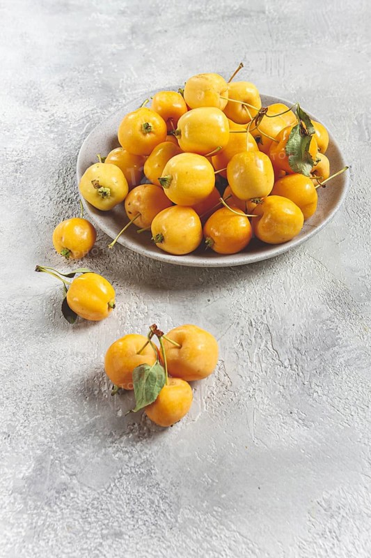 Yellow small apples, Chinese variety, on a gray plate, top view, no people