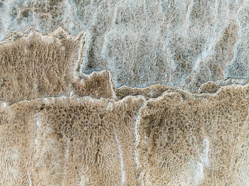Abstract patterns of saline deposits at the salt works of Walvis Bay. Aerial view. Drone shot. Namibia