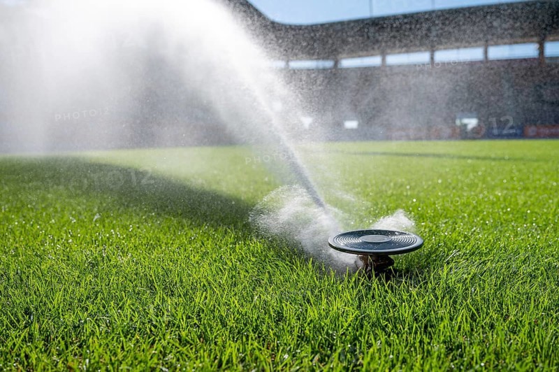 Watering grass on a football stadium in Lubin, Poland