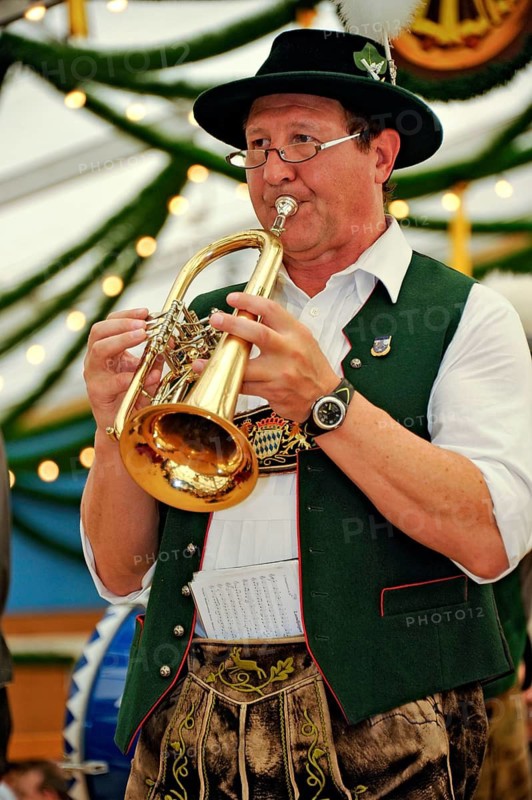 Musician of a Bavarian brass band in traditional traditional costume with lederhosen playing trumpet, old marquee, historic Wies'n, Oide Wiesn, Oktoberfest, Munich, Upper Bavaria, Bavaria, Germany