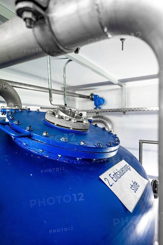 Detail of a blue tank with silver pipework and labelling, ENCW Netze Calw waterworks, Calw, Black Forest, Germany