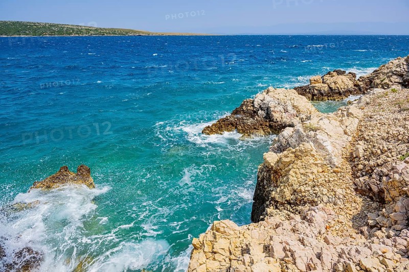 Romantic view over the sea in Koromacna Bay on a sunny day with rough seas on the island of Cres, long exposure, Croatia