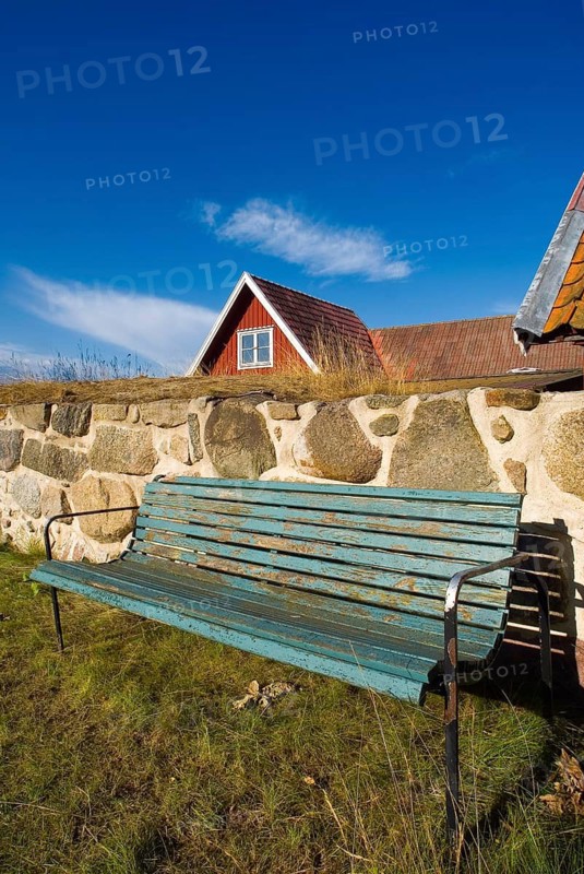 Park bench, bench, wooden bench in front of a wooden house in Karlskrona, Sweden