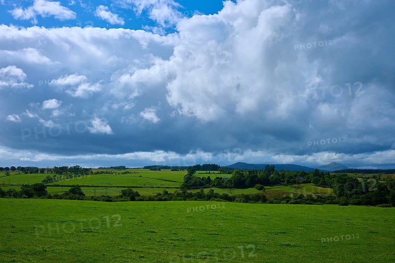 Wide green fields and hills under a cloudy sky, Scotland, United Kingdom, Great Britain