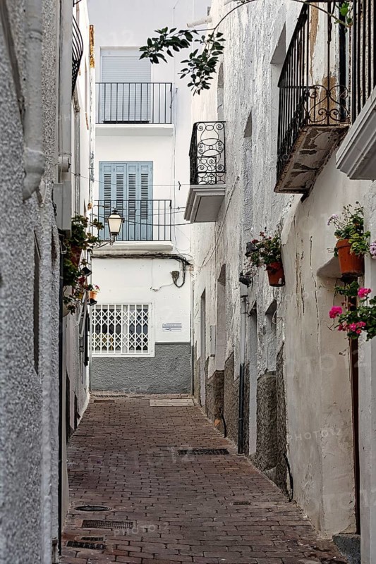 Typical narrow alley with small balconies, old town of Mojácar, Almería, Andalucia, Spain