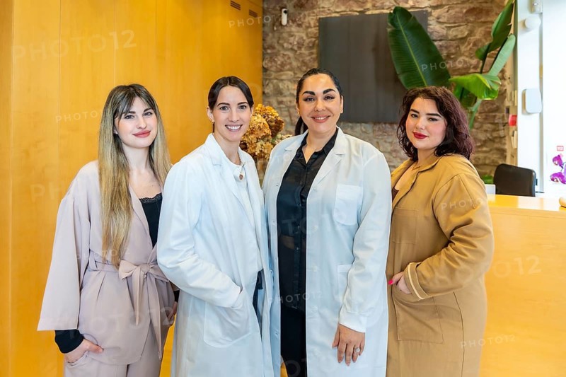 Diverse women medical staff and receptionists smiling confidently, representing professionalism, expertise, and patient care in a modern aesthetic clinic or medical office setting